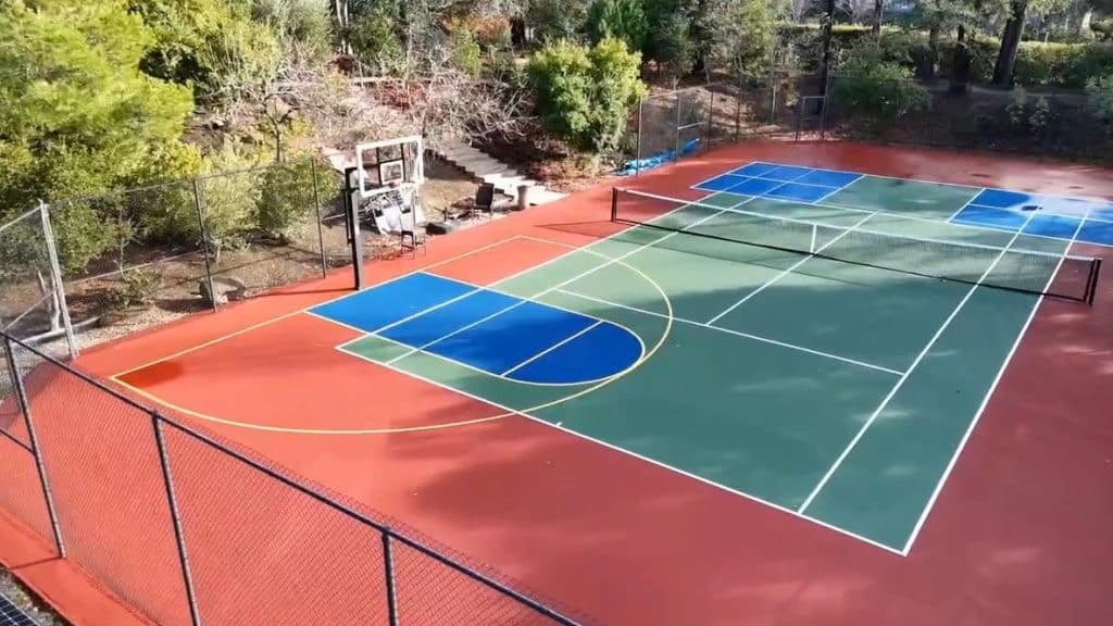 Outdoor multi-sport court with basketball hoops and tennis markings